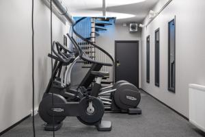a gym with a treadmill and a elliptical machine at Clarion Hotel Air in Sola
