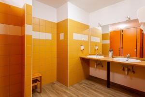 a bathroom with two sinks and two mirrors at Yapka Rooms in Tolmin