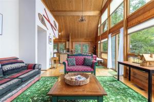 a living room with a couch and a table at Trails End | Hot Tub, Starlink, Woodstove in Packwood
