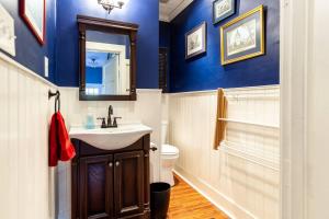 a bathroom with blue walls and a sink and a toilet at Crew's Quarters in Annapolis +40 photos