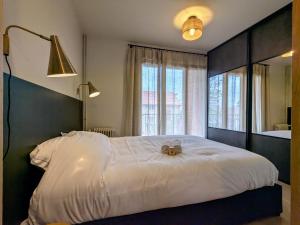 a bedroom with a large white bed with two teddy bears on it at Le sublime in Le Coteau