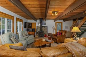a living room with a couch and chairs and a table at Wonderland Chateau in Packwood