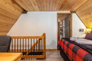 a bedroom with a bed and a wooden ceiling at Wonderland Chateau in Packwood