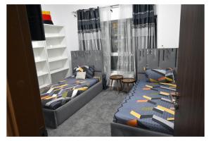a bedroom with two beds and a table and chairs at Ajman Pearl Tawer Block B4-807 in Ajman 