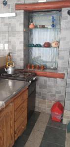 a kitchen with a stove and a counter top at Inti Mayu in Villa Cura Brochero