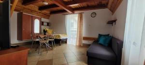a living room with a couch and a table at Kama Pobierowo in Pobierowo