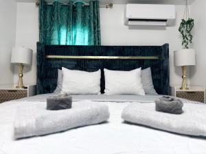 a bedroom with a large bed with two pillows on it at Home away from home in Dover