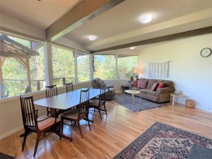a living room with a table and chairs and a couch at Valley View Cabin | AC, Fireplace, BBQ, Mt. View in Packwood