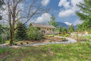a home in the mountains with a pathway leading to a house at The Alpenhaus in Packwood