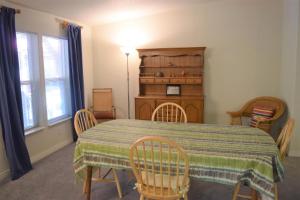 a dining room with a table and chairs and a table and a table and chairs at Rustic Rapids · Wood Stove, Creek, Sauna in Packwood