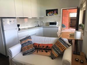 a white couch with pillows on it in a kitchen at Relaxando no campo in Viana do Castelo