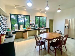 a kitchen with a table and chairs in a kitchen at There's A Borneo Guesthouse in Johor Bahru +14 photos