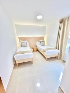 a bedroom with two beds and a window at VV Canary Islands 1 in San Miguel de Abona