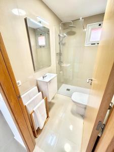 a bathroom with a shower toilet and a sink at VV Canary Islands 1 in San Miguel de Abona +14 photos
