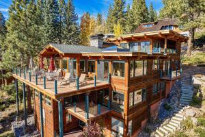a wooden house with a wrap around deck at Clouds Rest in Dollar Point By Tahoe Getaways - Lake views - Hot Tub & Game Room in Tahoe City