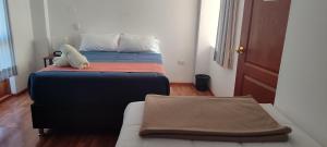A bed or beds in a room at Anata Hotel