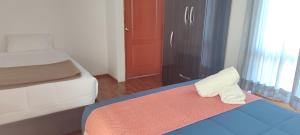 A bed or beds in a room at Anata Hotel