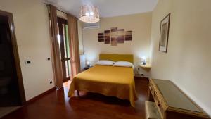 a bedroom with a bed with a yellow blanket at B&B Villa Sabrina in Arezzo +94 photos