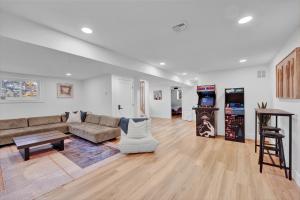a living room with a couch and a table at Lakeside, Dock, Hot Tub, Kayaks, Arcade, Playset in Lake Ariel