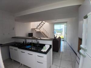 a kitchen with a sink and a staircase at Mirante da Chácara in Nova Friburgo