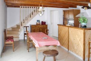 a kitchen and dining room with a table and a staircase at Maison accueillante à Saint-Gènes-Champespe + Vue sur le lac in Saint-Genès-Champespe +11 photos