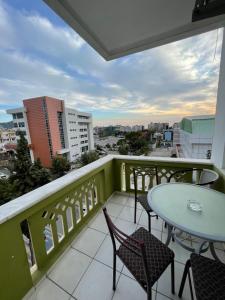 a balcony with tables and chairs and a view of a city at Best Life Apart Hotel in Alanya