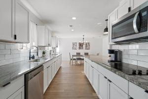 a kitchen with white cabinets and a counter top at hot tub and Event Open Luxury Home Fits 16 plus in Dallas