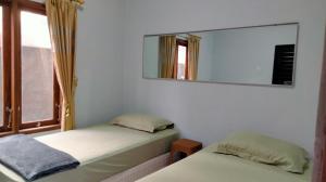 Postel nebo postele na pokoji v ubytování Homestay Rumah Bahagia Cepor