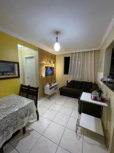 a living room with a bed and a couch at Apartamento em condomínio COP30 in Marituba
