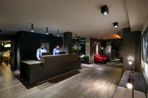 two people standing at a counter in a lobby at Upper Diagonal in Barcelona