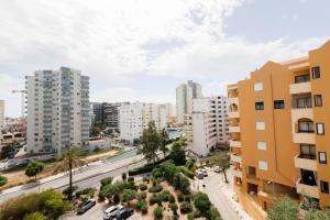an aerial view of a city with tall buildings at NayJay Staycation in Portimão