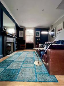 a living room with a couch and a rug at Stylish city centre house, perfectly located in Dublin