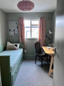 a small bedroom with a bed and a desk at Stylish city centre house, perfectly located in Dublin +20 photos