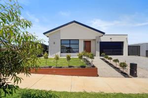 a white house with a driveway at Stunning Beach Side Family Home in St Leonards in Saint Leonards