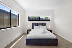 a bedroom with a bed and a large window at Stunning Beach Side Family Home in St Leonards in Saint Leonards