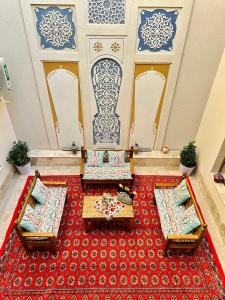 a room with two tables and a red carpet at Daro Boutique in Bukhara
