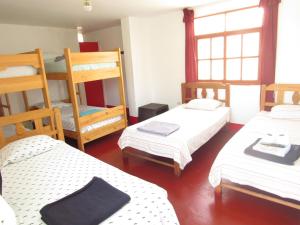 a room with three beds and a bunk bed at Hospedaje snack bar titanic in Ica +108 photos
