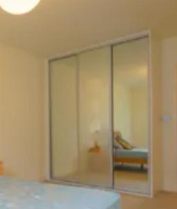 a bedroom with a large glass wall at The forty in Bexleyheath