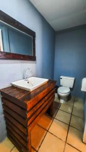 a bathroom with a sink and a toilet at Hola Ola Hostel in San Juan del Sur