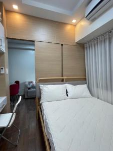马尼拉Beauty Makati Penthouse 4 room Family Condo的卧室里有一张带木质床头板的床