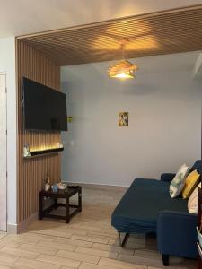 a living room with a couch and a flat screen tv at Refugio caracol in Claridad