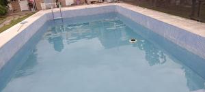 a swimming pool with blue water in a house at XayEm Apart in Villa Carlos Paz
