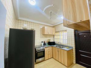 a kitchen with a black refrigerator and a stove at Danso apartment in Tokuse