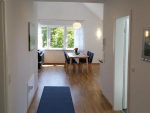 a living room with a table and a window at Beech Modern Retreat in Hödingen