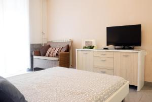 a bedroom with a bed and a flat screen tv at Apartments Marjana in Portorož