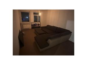 a living room with a couch and a television at Gießler Comfortable holiday residence in Bremerhaven