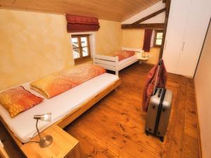 a bedroom with two beds and a suitcase at Oberprill Modern retreat in Loitzendorf