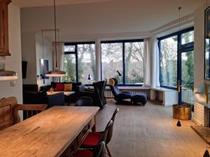 a living room with a table and some chairs at The Blue House Modern retreat in Wangerooge