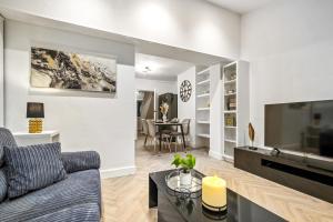 a living room with a couch and a table at Luxury Cozy 2 bed house hot tub family friendly business traveler family of 4 - 6 with parking close to Birmingham city centre , M6 , Aston univerity , Great Barr Birmingham in Birmingham