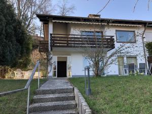 a white house with stairs in front of it at Villa Alpenblick Comfortable holiday residence in Füssen